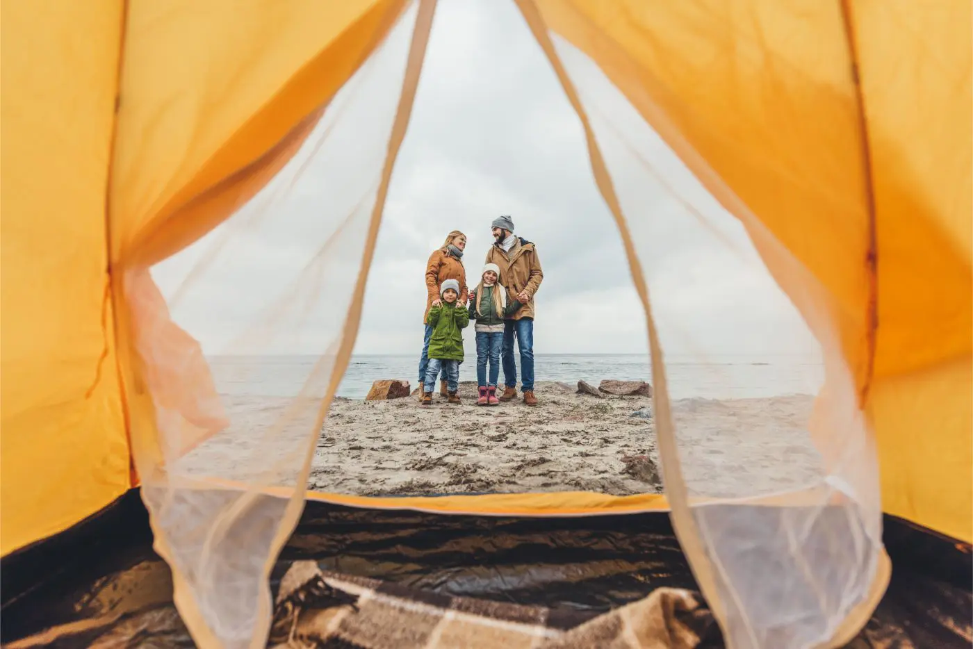 A family backpacking and camping on the beach